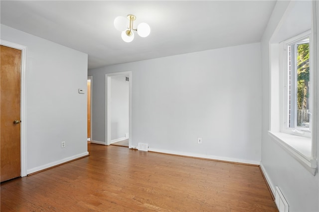 3917 Beechwood Blvd, Squirrel Hill, PA 15217 - empty room featuring wood finished floors and a chandelier