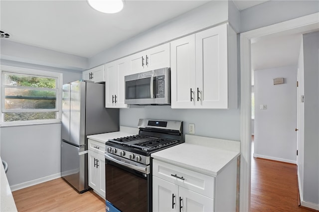 3917 Beechwood Blvd, Squirrel Hill, PA 15217 - kitchen with appliances with stainless steel finishes, light countertops, white cabinetry, and light wood finished floors