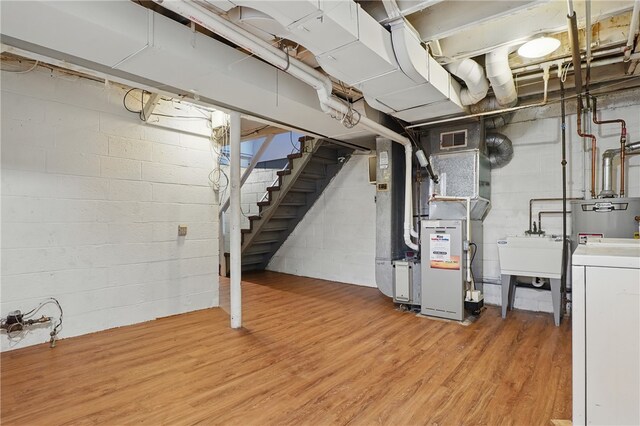 3917 Beechwood Blvd, Squirrel Hill, PA 15217 - unfinished basement featuring washer / clothes dryer, light wood-type flooring, water heater, stairway, and concrete block wall