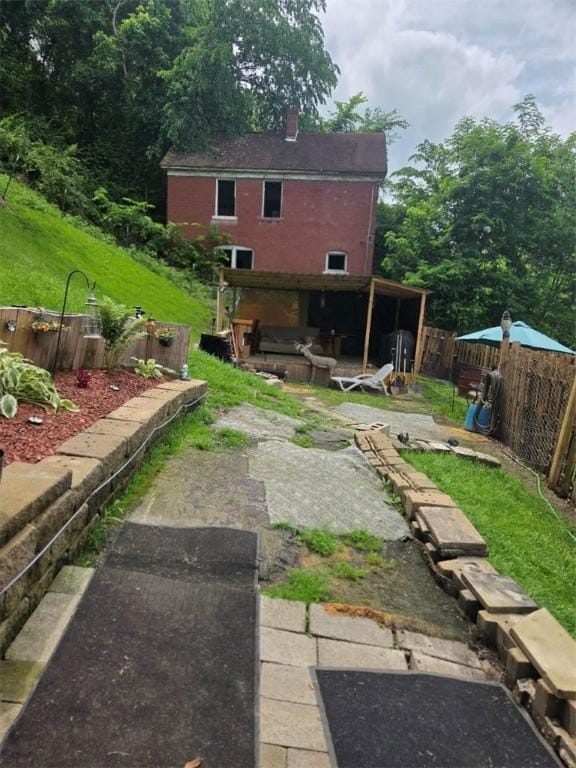 1243 2nd St, Brownsville, PA 15417 - back of house with a patio area, a chimney, and a jacuzzi