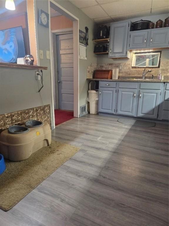 1243 2nd St, Brownsville, PA 15417 - kitchen featuring a paneled ceiling, gray cabinets, light wood finished floors, backsplash, and open shelves