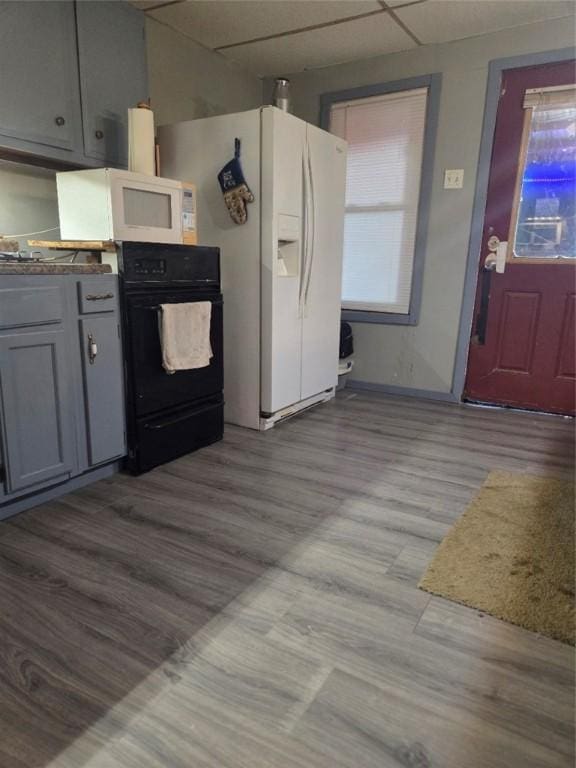 1243 2nd St, Brownsville, PA 15417 - kitchen featuring white appliances, wood finished floors, gray cabinets, and a paneled ceiling