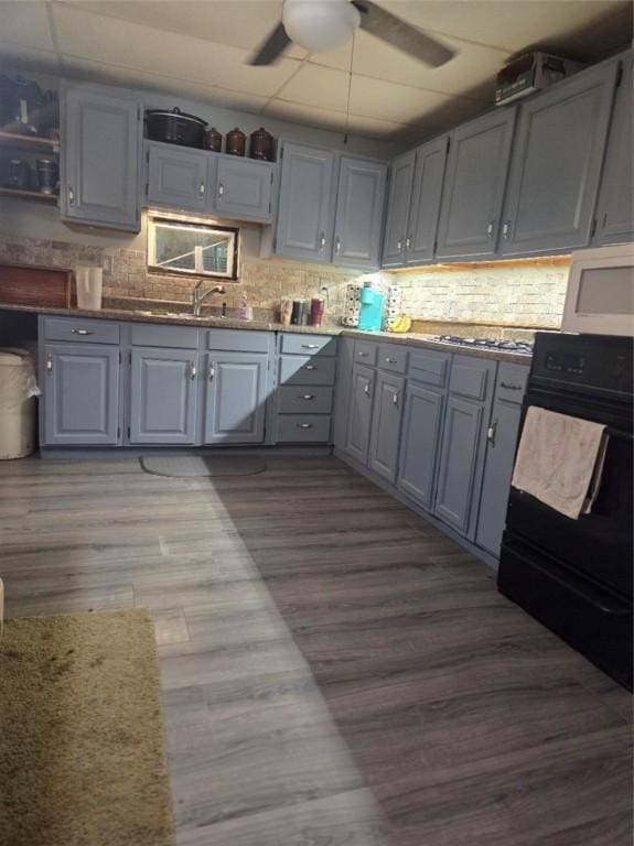 1243 2nd St, Brownsville, PA 15417 - kitchen featuring white microwave, gray cabinets, ceiling fan, and dark wood-type flooring