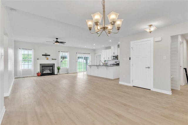 313 Camden Dr, Lehigh Twp, PA 16063 - unfurnished living room featuring ceiling fan, a glass covered fireplace, light wood finished floors, a chandelier, and recessed lighting