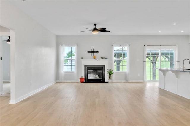 313 Camden Dr, Lehigh Twp, PA 16063 - unfurnished living room featuring a ceiling fan, light wood-type flooring, plenty of natural light, a fireplace with flush hearth, and recessed lighting