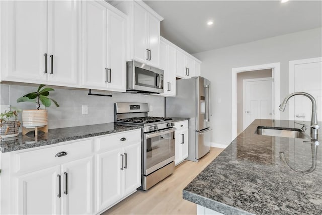 313 Camden Dr, Lehigh Twp, PA 16063 - kitchen featuring appliances with stainless steel finishes, white cabinets, backsplash, light wood finished floors, and recessed lighting