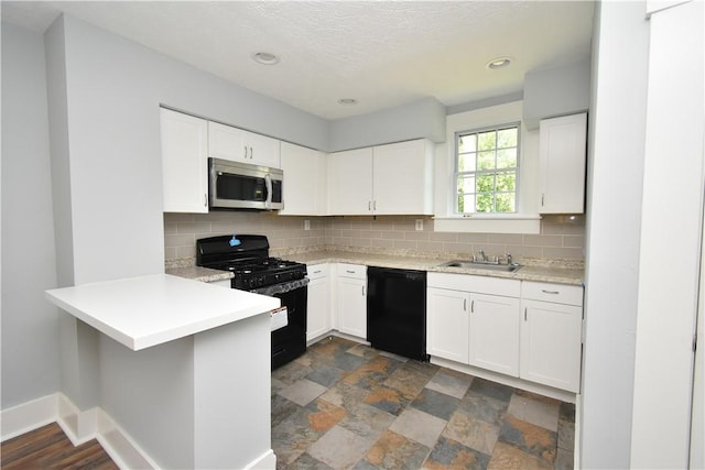 2300 Palm Beach Ave, Beechview, PA 15216 - kitchen featuring black appliances, a peninsula, light countertops, tasteful backsplash, and recessed lighting