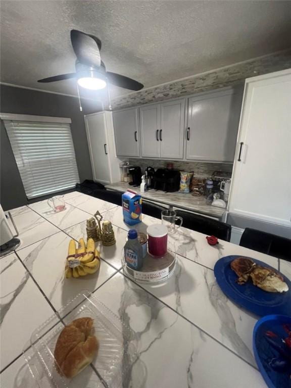 3539 York St, Munhall, PA 15120 - kitchen with light countertops, marble look tiles, a textured ceiling, a ceiling fan, and backsplash