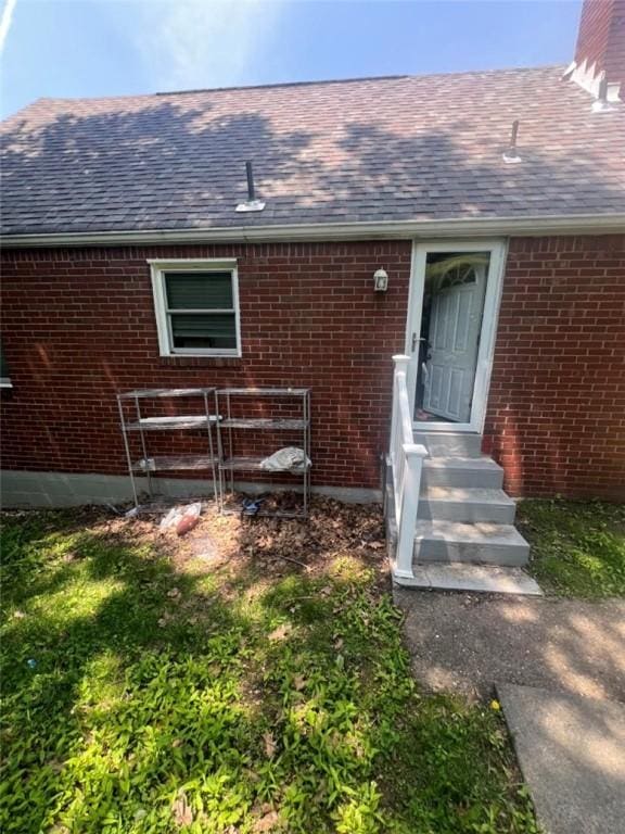 3539 York St, Munhall, PA 15120 - property entrance with brick siding, a shingled roof, and a chimney