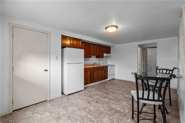 435 Walde St, Mount Oliver, PA 15210 - kitchen with white appliances, light countertops, and under cabinet range hood