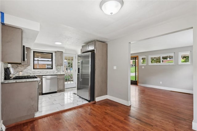 330 Delaney Dr, Wilkins Twp, PA 15235 - kitchen featuring appliances with stainless steel finishes, backsplash, light countertops, and plenty of natural light