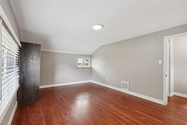 330 Delaney Dr, Wilkins Twp, PA 15235 - bonus room with wood finished floors, vaulted ceiling, and a textured ceiling