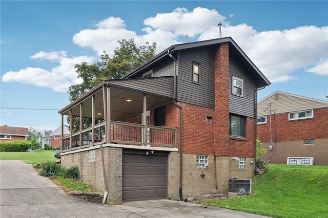 330 Delaney Dr, Wilkins Twp, PA 15235 - view of side of property featuring a garage, a lawn, brick siding, and a balcony