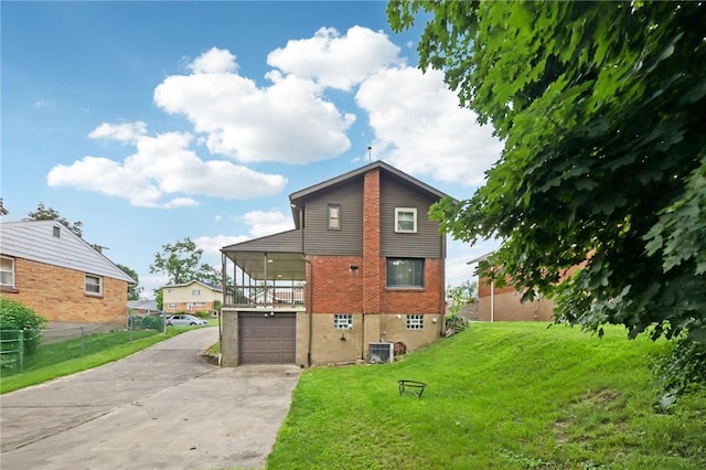 330 Delaney Dr, Wilkins Twp, PA 15235 - back of property with concrete driveway, a garage, and brick siding