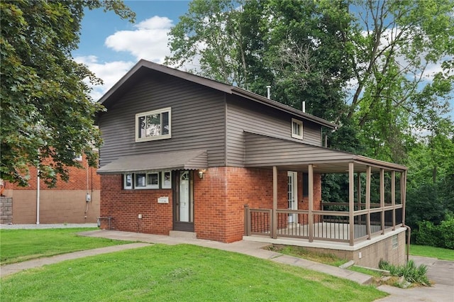 330 Delaney Dr, Wilkins Twp, PA 15235 - view of front of home with a porch, brick siding, and a front lawn
