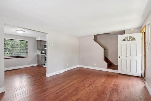 330 Delaney Dr, Wilkins Twp, PA 15235 - unfurnished living room with dark wood-style flooring and stairway