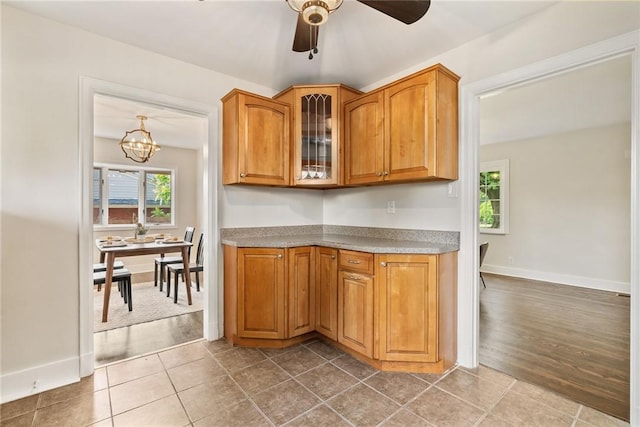 112 Taylor Run Rd, Monongahela, PA 15063 - kitchen featuring plenty of natural light, brown cabinetry, glass insert cabinets, and a ceiling fan