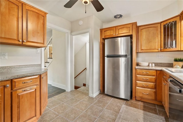 112 Taylor Run Rd, Monongahela, PA 15063 - kitchen featuring stainless steel appliances, ceiling fan, brown cabinets, glass insert cabinets, and light tile patterned floors