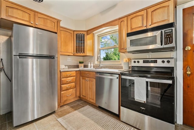 112 Taylor Run Rd, Monongahela, PA 15063 - kitchen featuring stainless steel appliances, glass insert cabinets, light countertops, light tile patterned floors, and brown cabinets