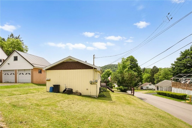 501 Bay, Stonycreek Twp, PA 15902 - view of side of home with a detached garage, a yard, and an outbuilding