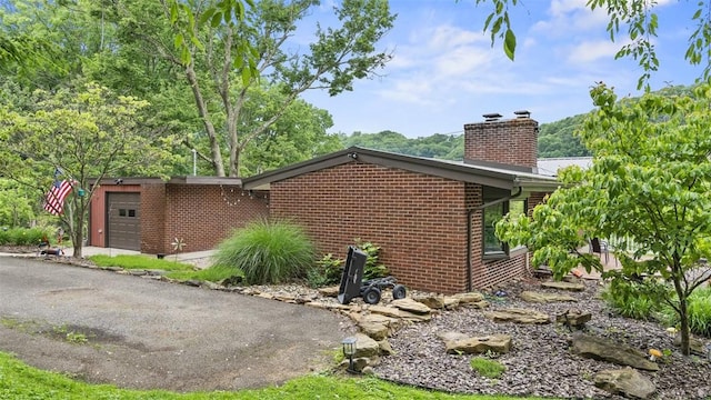 1451 Keystone St, Natrona Hts/Harrison Twp, PA 15065 - view of side of home with a chimney, brick siding, and an attached garage