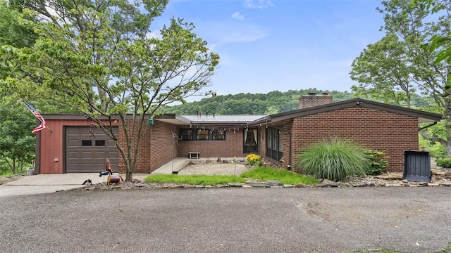1451 Keystone St, Natrona Hts/Harrison Twp, PA 15065 - ranch-style home featuring a garage, brick siding, a chimney, and driveway