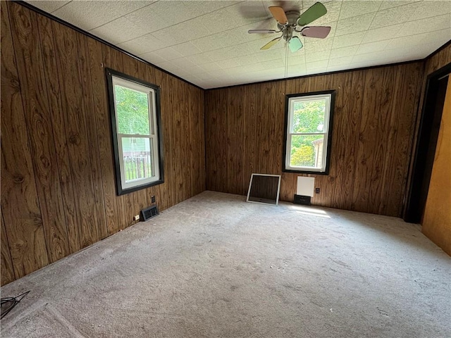 3112 Ridge Ave, Hopewell Twp Bea, PA 15001 - empty room with healthy amount of natural light, carpet flooring, a ceiling fan, and wood walls