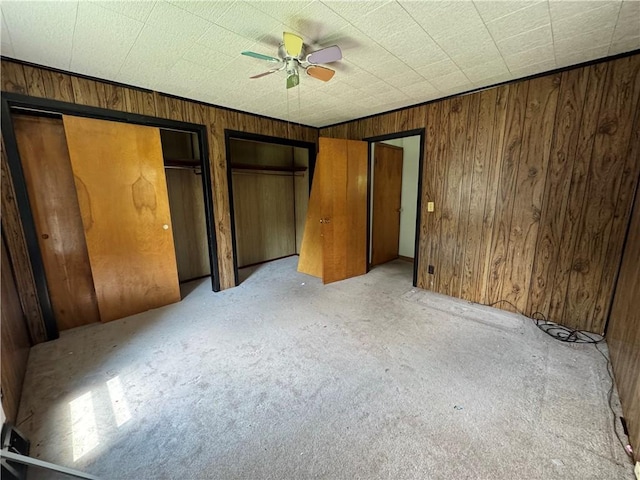 3112 Ridge Ave, Hopewell Twp Bea, PA 15001 - unfurnished bedroom with two closets, wood walls, light colored carpet, and ceiling fan