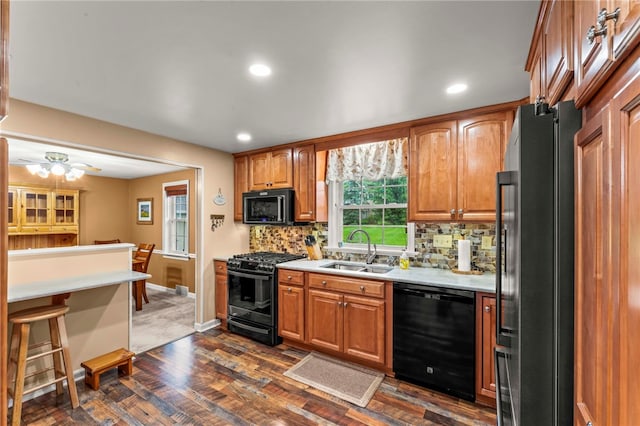 295 Sugar Cp, Peters Twp, PA 15367 - kitchen with black appliances, light countertops, decorative backsplash, dark wood finished floors, and brown cabinets