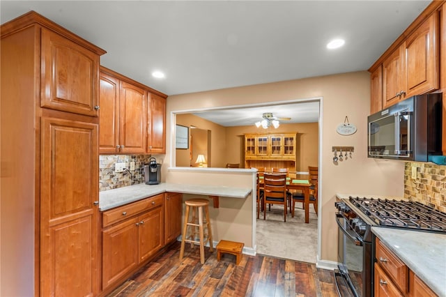 295 Sugar Cp, Peters Twp, PA 15367 - kitchen featuring black appliances, dark wood finished floors, backsplash, brown cabinets, and recessed lighting