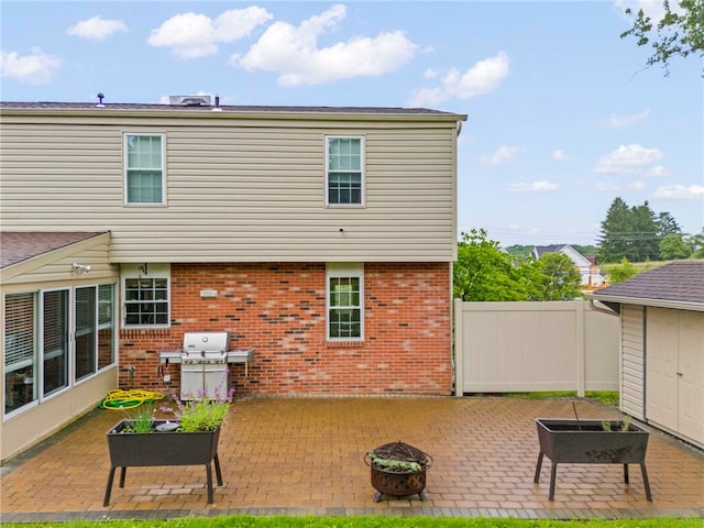 295 Sugar Cp, Peters Twp, PA 15367 - back of house with a patio, an outdoor fire pit, and brick siding