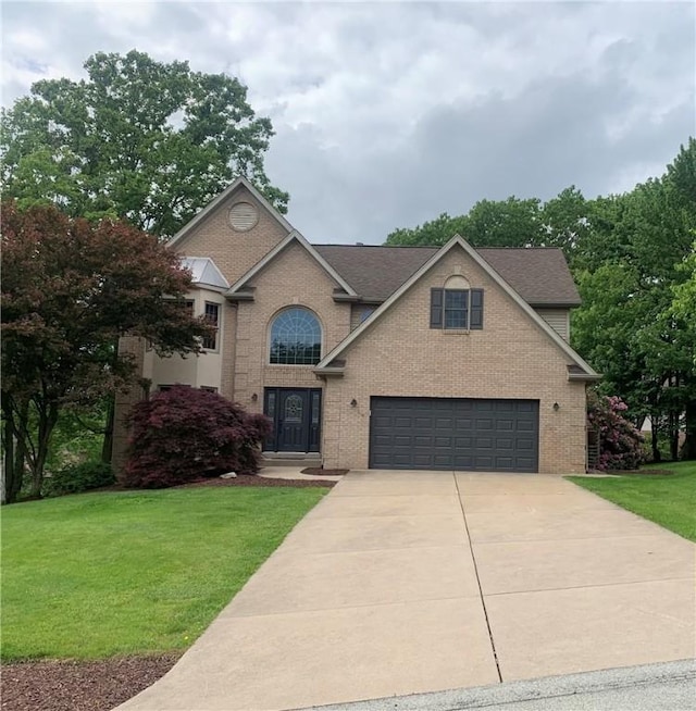 306 Marigold Dr, Unity Twp, PA 15601 - traditional home featuring brick siding, a front yard, concrete driveway, an attached garage, and roof with shingles
