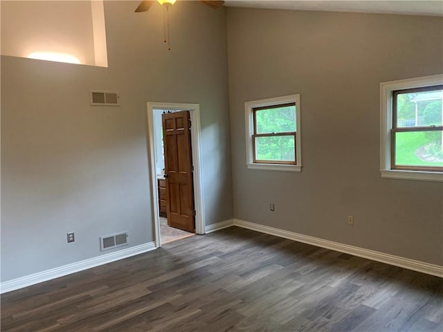 306 Marigold Dr, Unity Twp, PA 15601 - empty room featuring healthy amount of natural light, high vaulted ceiling, dark wood-style floors, and a ceiling fan