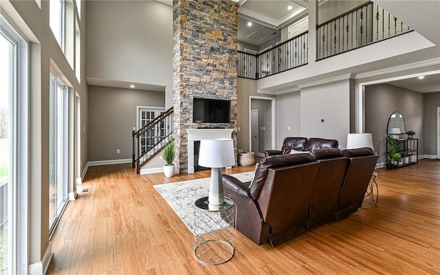 1191 Brook View Ct, Mccandless, PA 15237 - living room with a high ceiling, stairway, plenty of natural light, wood finished floors, and a fireplace