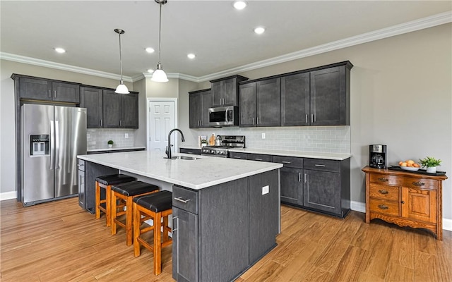 1191 Brook View Ct, Mccandless, PA 15237 - kitchen with appliances with stainless steel finishes, light wood-style floors, ornamental molding, backsplash, and an island with sink