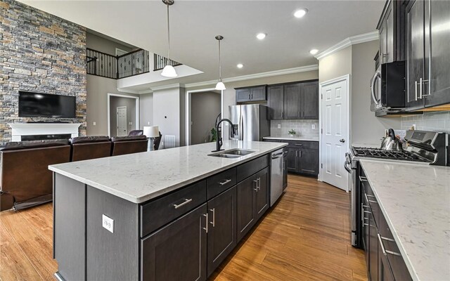 1191 Brook View Ct, Mccandless, PA 15237 - kitchen featuring appliances with stainless steel finishes, crown molding, open floor plan, decorative backsplash, and wood finished floors