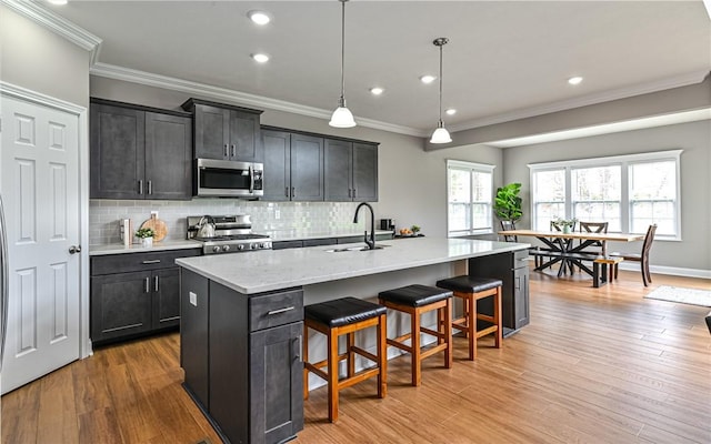 1191 Brook View Ct, Mccandless, PA 15237 - kitchen featuring appliances with stainless steel finishes, crown molding, backsplash, a breakfast bar area, and recessed lighting