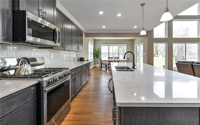 1191 Brook View Ct, Mccandless, PA 15237 - kitchen with stainless steel appliances, wood finished floors, open floor plan, an island with sink, and tasteful backsplash