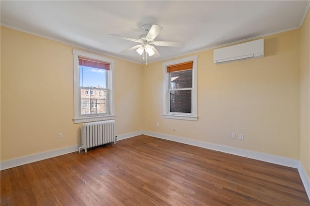 3485 Beechwood Blvd, Greenfield, PA 15217 - empty room with radiator heating unit, a wall unit AC, hardwood / wood-style flooring, crown molding, and a ceiling fan