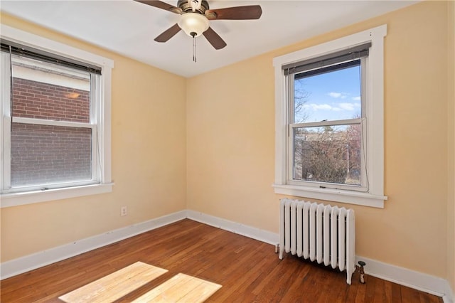 3485 Beechwood Blvd, Greenfield, PA 15217 - empty room featuring radiator heating unit, healthy amount of natural light, wood finished floors, and a ceiling fan
