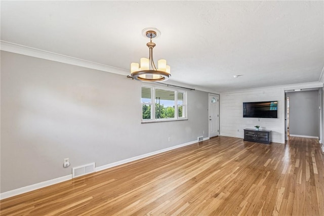 4100 Burnsire Dr, Hempfield Twp Wml, PA 15642 - unfurnished living room featuring ornamental molding, a chandelier, and wood finished floors