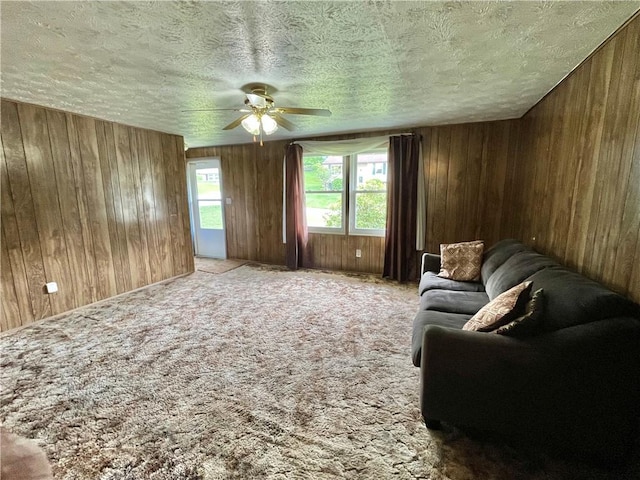 1974 Tara Dr, North Huntingdon, PA 15642 - carpeted living room with a ceiling fan, wooden walls, and a textured ceiling