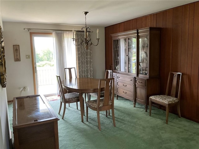 143 Herbst Rd, Kennedy Twp, PA 15108 - dining space with a chandelier, light colored carpet, and wood walls