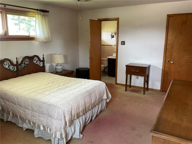 143 Herbst Rd, Kennedy Twp, PA 15108 - carpeted bedroom with connected bathroom and baseboards