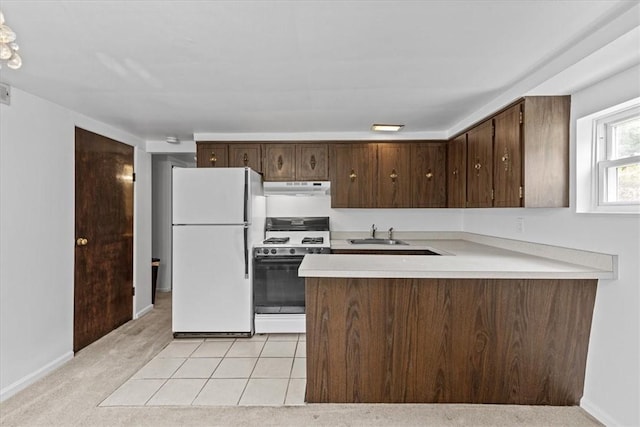 737 Spring Grove Rd, Ohara, PA 15215 - kitchen featuring white appliances, under cabinet range hood, light countertops, and dark brown cabinetry