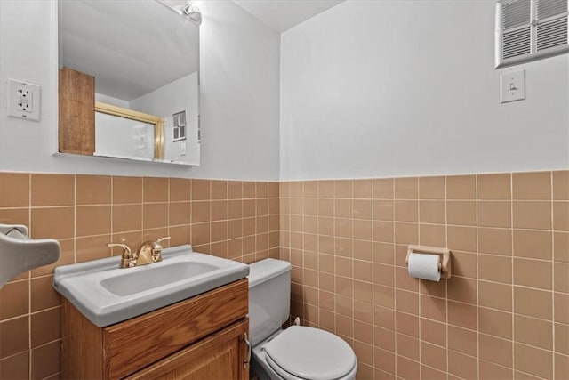 737 Spring Grove Rd, Ohara, PA 15215 - bathroom with vanity, tile walls, and wainscoting