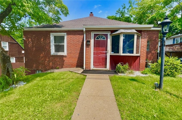 201 Esther Ave, New Kensington, PA 15068 - bungalow-style home featuring a front yard, brick siding, and a chimney