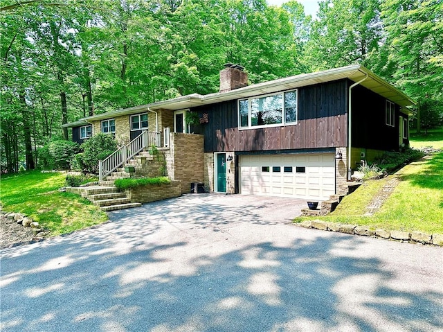 315 Lake Dr, Neshannock Twp, PA 16105 - raised ranch featuring driveway, a garage, a chimney, and brick siding