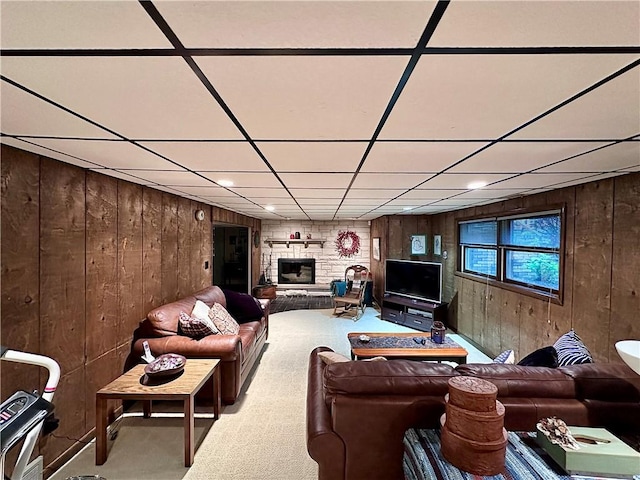 315 Lake Dr, Neshannock Twp, PA 16105 - living room featuring wooden walls, a drop ceiling, a stone fireplace, and carpet flooring