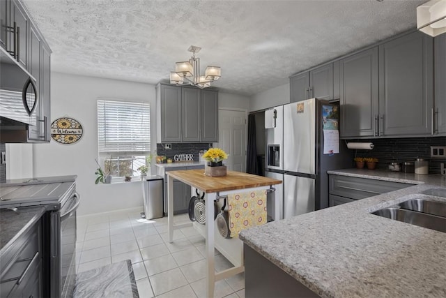 23 Sunset Ct, Cranberry Twp, PA 16066 - kitchen featuring gray cabinets, appliances with stainless steel finishes, backsplash, and a textured ceiling